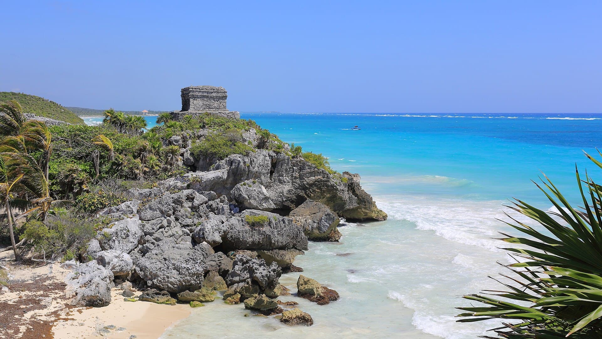 The Mayan ruins of Tulum on a cliff above a turquoise Caribbean beach